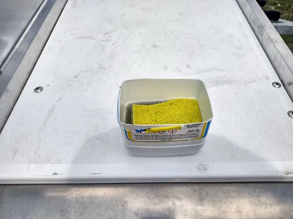 Place sponge in cleaner or spray onto sponge